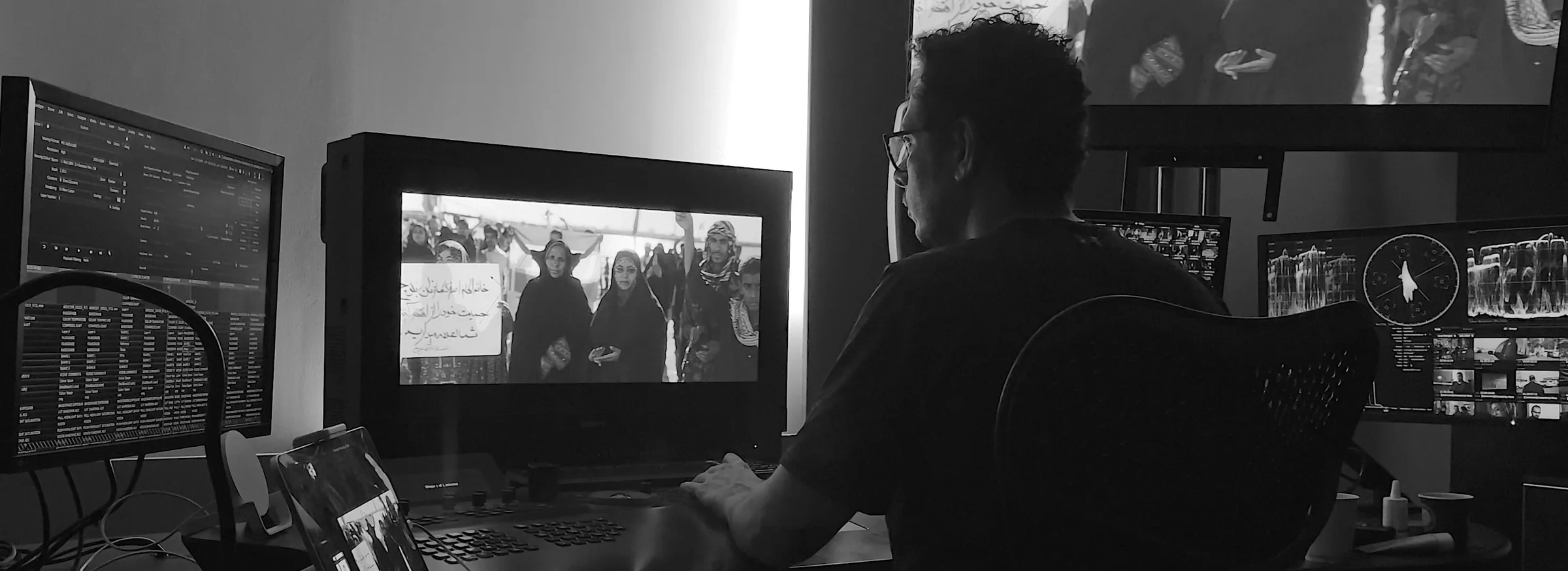 Fady Melek grading at the Baselight control surface with a reference monitor and scopes